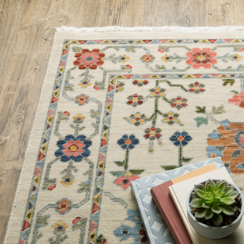 5' X 8' Ivory Salmon Pink Gold Blues Grey Rust And Green Oriental Power Loom Stain Resistant Area Rug With Fringe