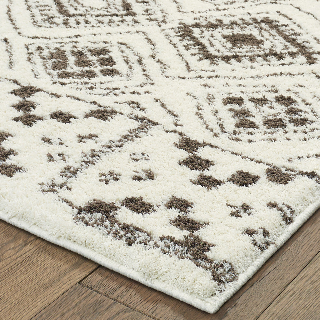 8' X 11' Ivory And Brown Geometric Shag Power Loom Stain Resistant Area Rug
