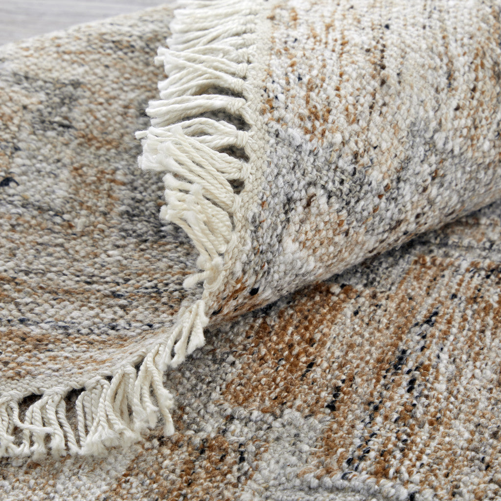 5' X 8' Tan Gray And Ivory Geometric Hand Woven Stain Resistant Area Rug With Fringe