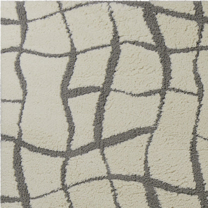5'X7' Ivory Machine Woven Abstract Indoor Shag Rug