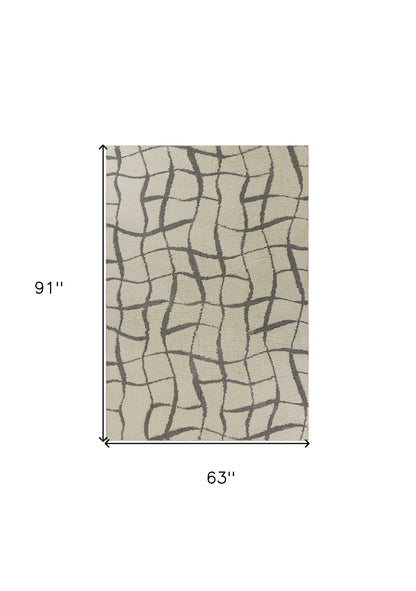 5'X7' Ivory Machine Woven Abstract Indoor Shag Rug